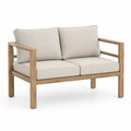 Dwuosobowa sofa z drewna teak z kremowymi poduszkami